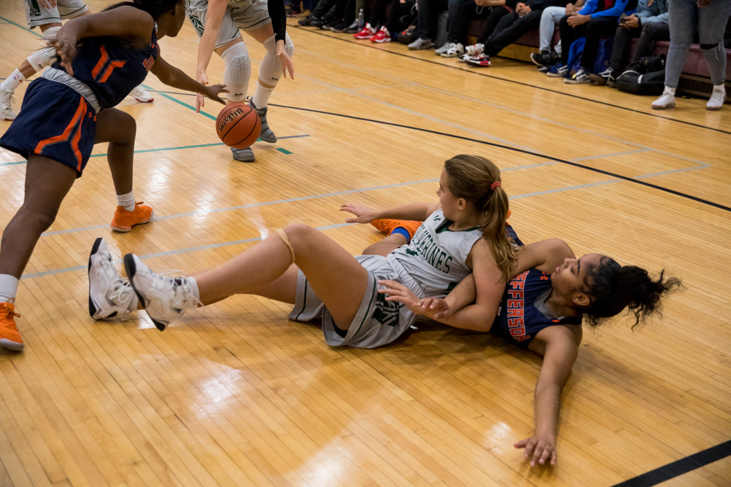 Bronx Science’s Lillian Flynn hits the floor to battle for a loose ball during the Wolverines’ 41-34 victory over Jefferson in a PSAL playoff game last week.