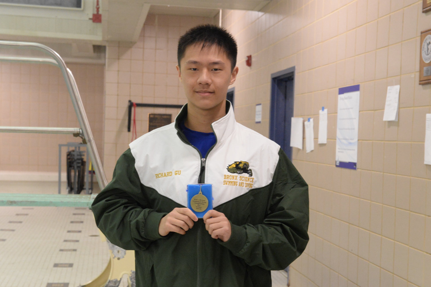 Bronx Science diver Richard Gu displays the medal he earned by finishing first in the Public School Athletic League’s city championships this season.