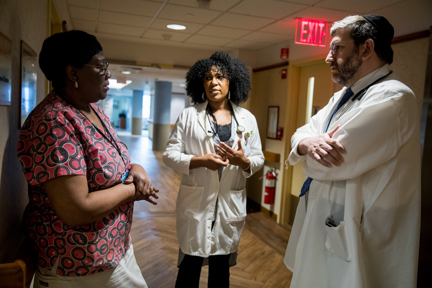 Patricia Salifu, a licensed practical nurse at the Hebrew Home at Riverdale, left, talks with nurse practitioner Sebrina Henderson and medical director Dr. Zachary Palace about a care plan for one of the Palisade Avenue facility’s residents.