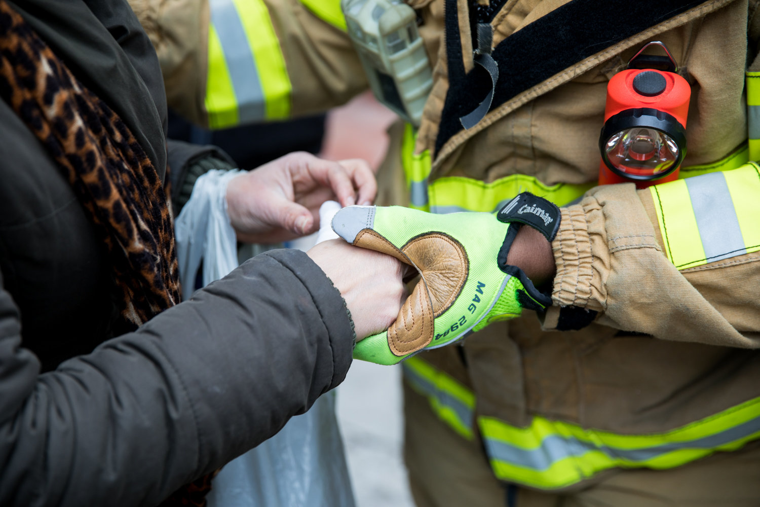 A resident of 215 W. 242nd St., where a one-alarm fire broke out Friday morning, gets her hand bandaged by emergency personnel. The fire injured 11 people, four critically and seven non-critically.