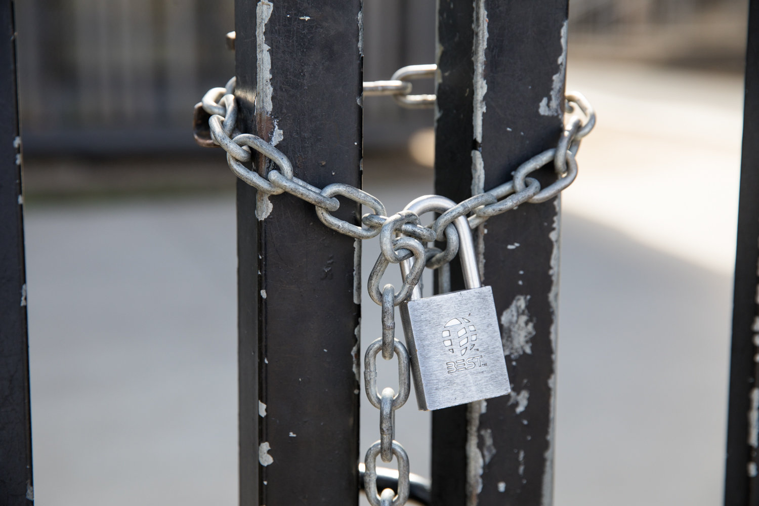 A lock and chain seals off a gate to Lehman College days after the campus was closed in response to the coronavirus outbreak.