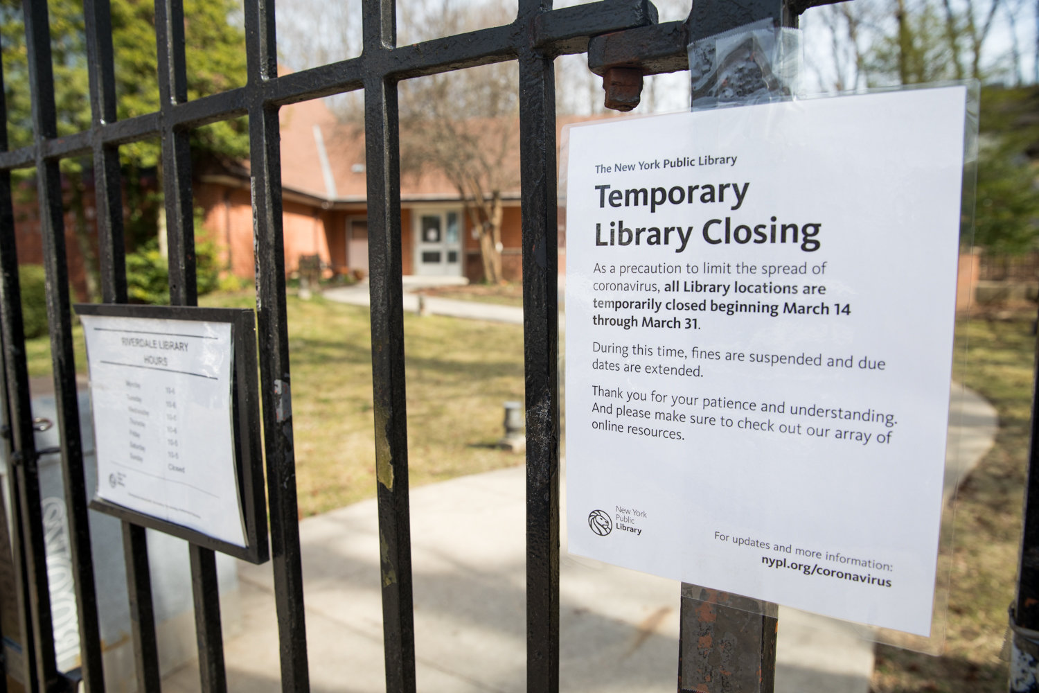 A sign announces the temporary closure of the Riverdale Library in response to the coronavirus outbreak. The library is scheduled to reopen March 31.