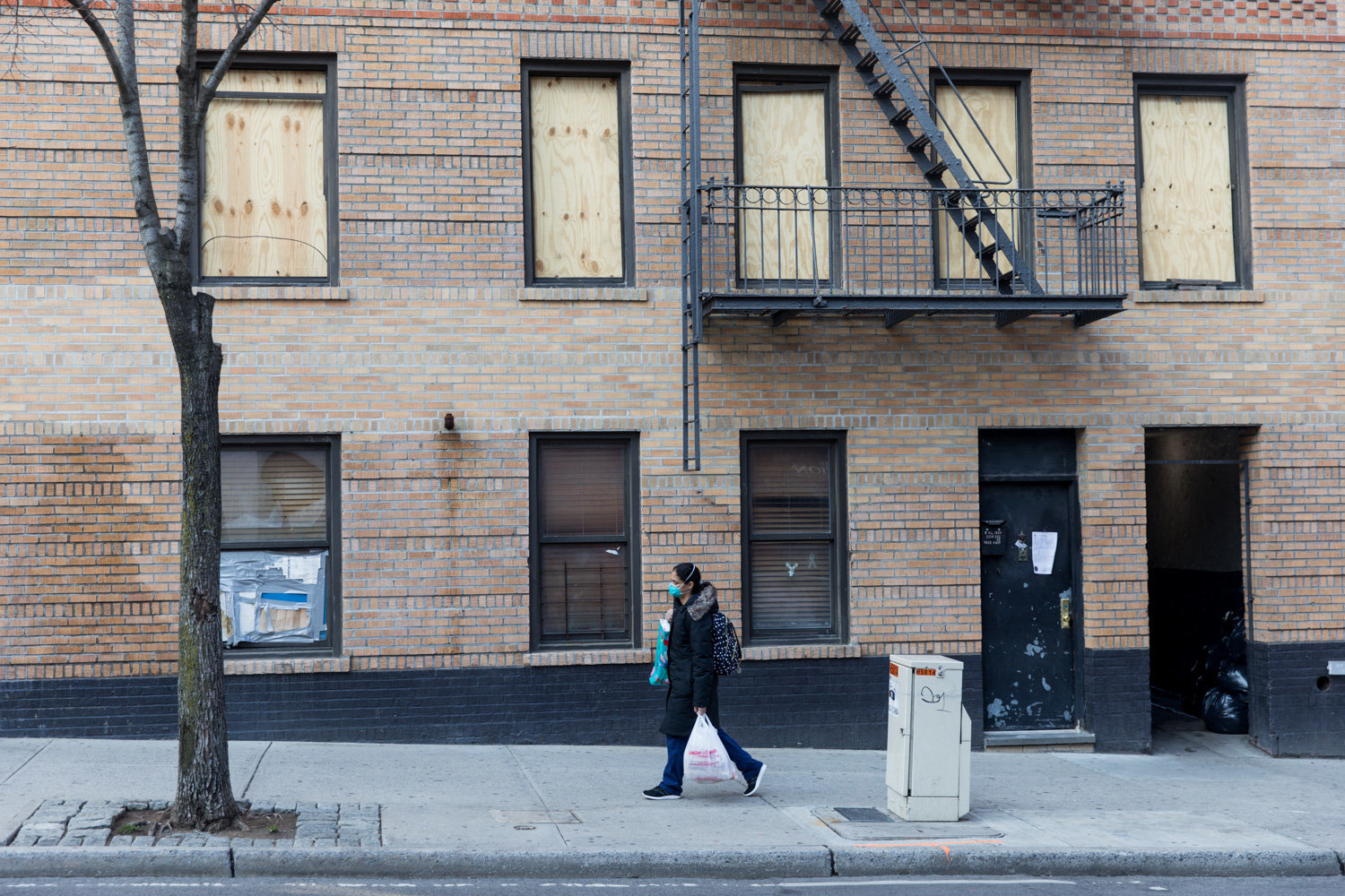 Windows are boarded up at 215 W. 242nd St., where a one-alarm fire injured 11 people March 6. Many were saved thanks to the efforts of Josh Pizarro, who knocked on as many doors as he could to warn his neighbors of the blaze.