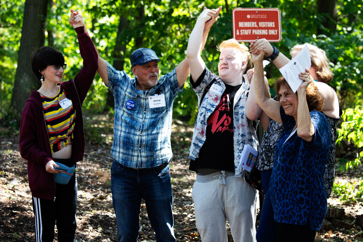 Jerry Goodman, second from left, cheers with attendees of a flag unveiling ceremony for the organizations PFLAG and Black Lives Matter at the Riverdale-Yonkers Society for Ethical Culture last year. The society has moved to take its services and activities online in response to the coronavirus pandemic.