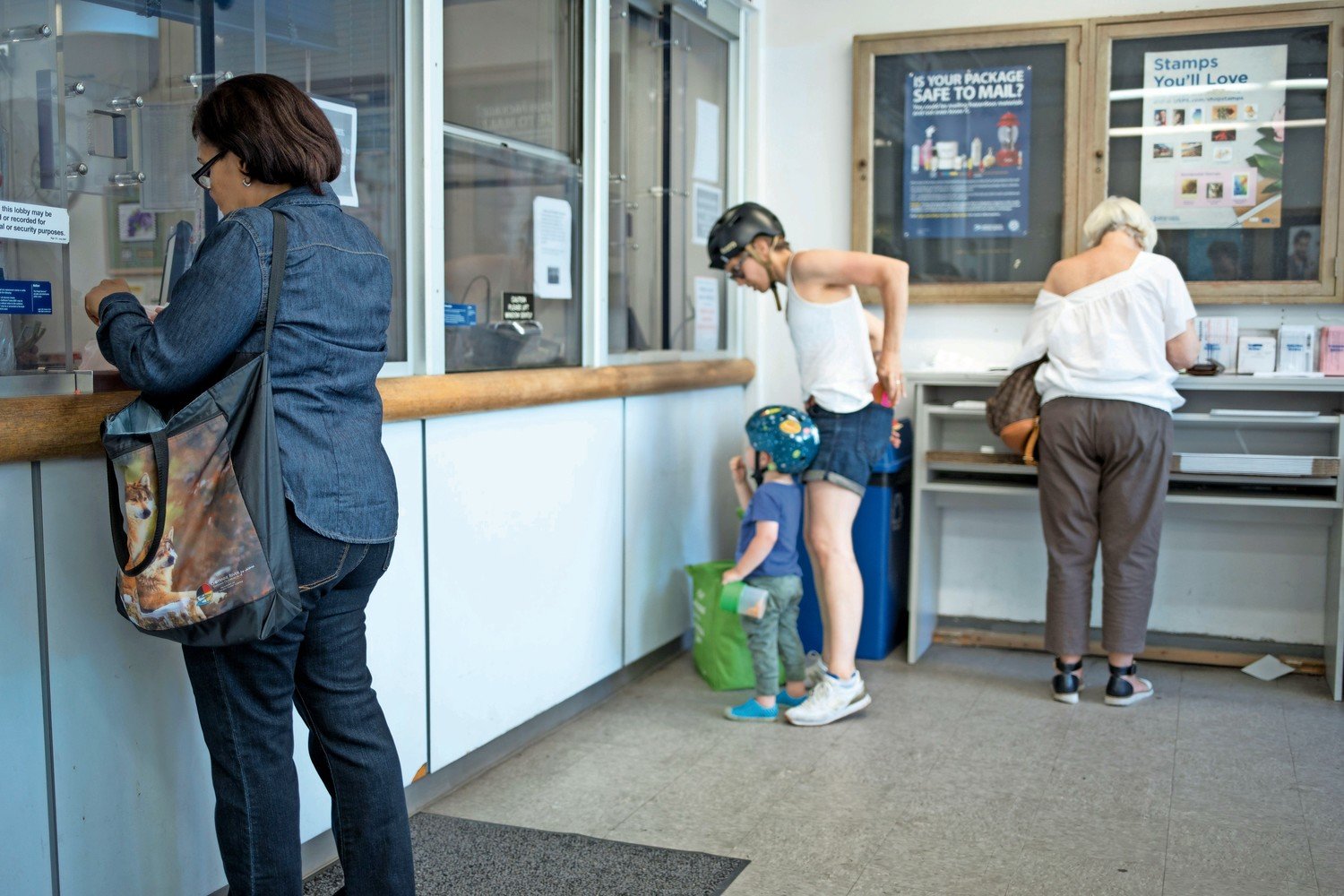 Customers take care of their postal needs at the post office on West 238th Street in Summer 2018. More recently, customers have complained about not receiving mail, primarily because this particular location is shut down because of the coronavirus pandemic.