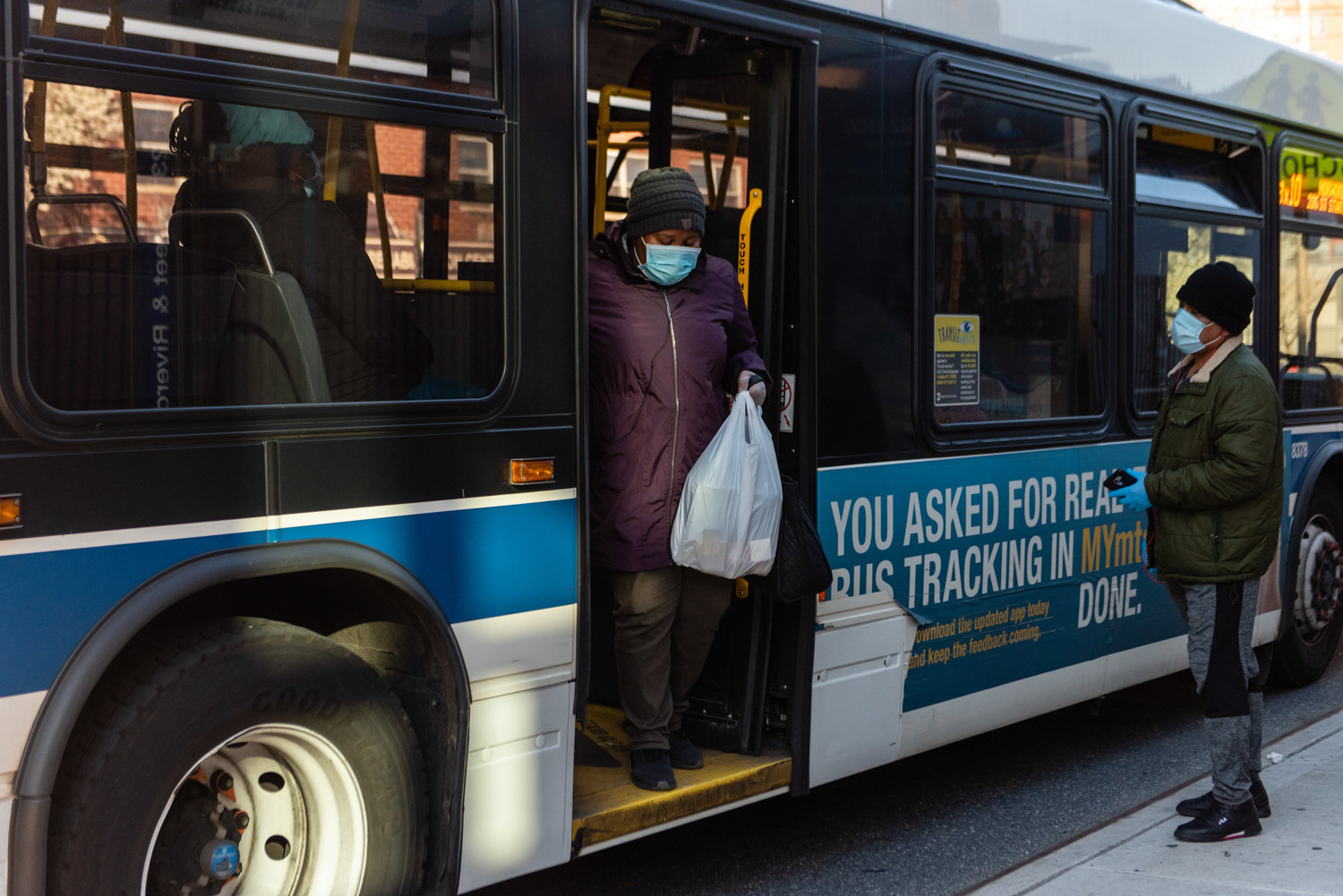 A commuter with a face mask disembarks from a Bx10 bus while another commuter waits on the street. It was a sign of life continuing for Frida Sterenberg, who has photographed how her neighborhood has changed as a result of the state’s shutdown in response to the coronavirus pandemic.