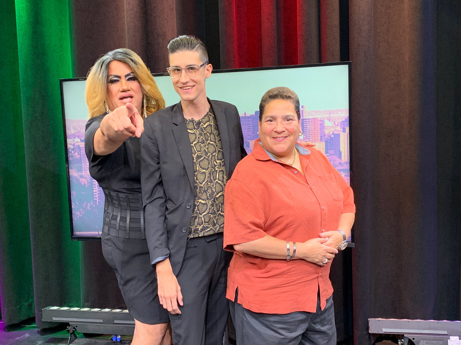 ‘Out Loud’ host Anthony Parker, center, stands with local personality Apollonia Cruz, left, better known as ‘Queen of the Bronx,’ as well as Audrey DeJesus, right, an entrepreneur who hopes to open a gay bar in the borough.