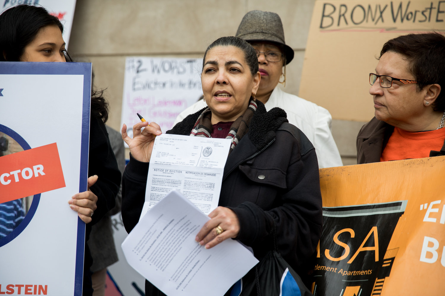 Digna Nuñez holds up an eviction notice she received, sharing in Spanish her experience with her landlord during a rally outside the Bronx Housing Civil Court last year. Since the advent of the coronavirus pandemic, renters have worried about how they will make rent and what the ramifications will be if they can’t.