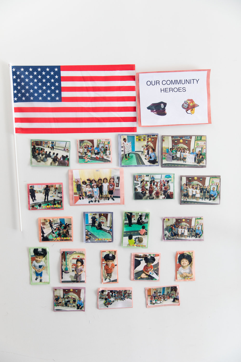 A wall of photographs honors community heroes inside the entrance of The Learning Experience, which is providing day care to the children of essential workers.