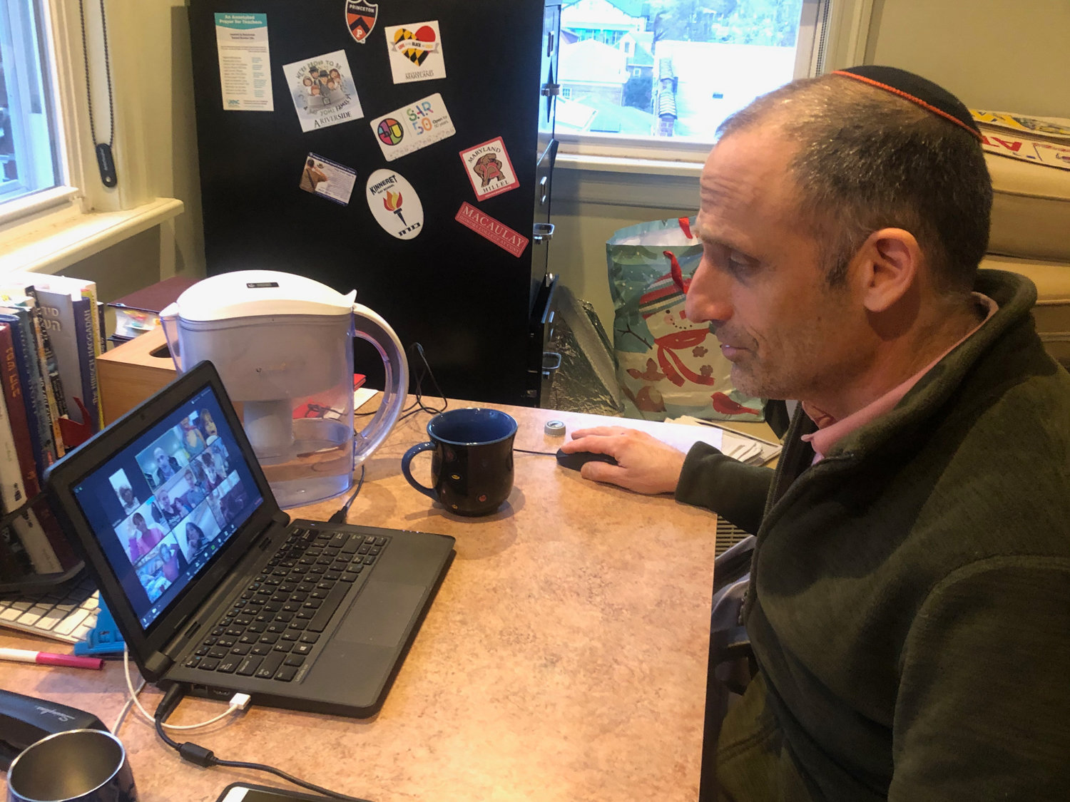 Kinneret Day School head Rabbi Aaron Frank teaches a class virtually over the videoconferencing app Zoom. Schools like Kinneret have shifted to an online learning model as a consequence of the coronavirus pandemic.