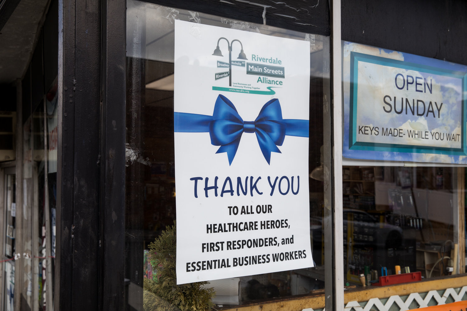 A sign thanking health care and essential workers is posted in the window of Cora Hardware on West 259th Street and Riverdale Avenue. The signs are a part of a thank you campaign by the Riverdale Main Streets Alliance.