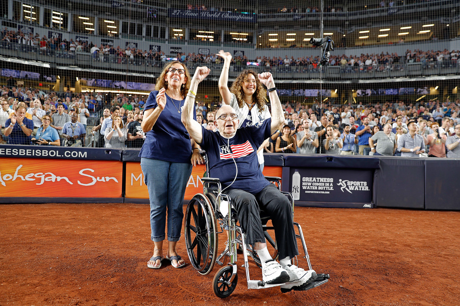 Alfred Schwartz cheers on the diamond at Yankee Stadium in 2018, joined by daughters Gayle and Heidi, right, who now grieve for him following his death on April 8 from complications related to COVID-19.