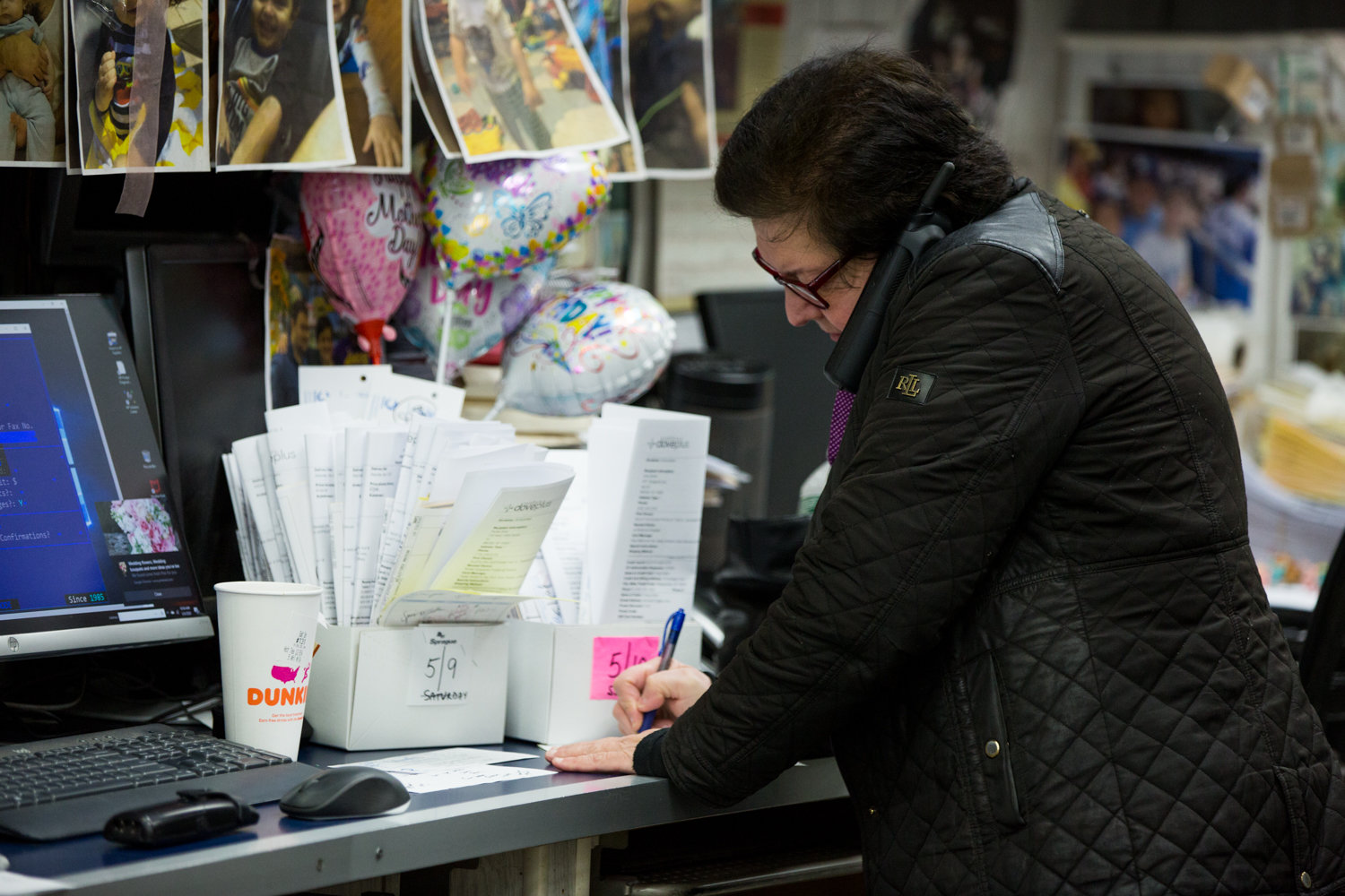 Columbia Florist co-owner Connie Dennis takes a customer’s order over the phone in the days leading up to Mother’s Day. The Kingsbridge floral mainstay has managed to stay open despite the statewide coronavirus shutdown.
