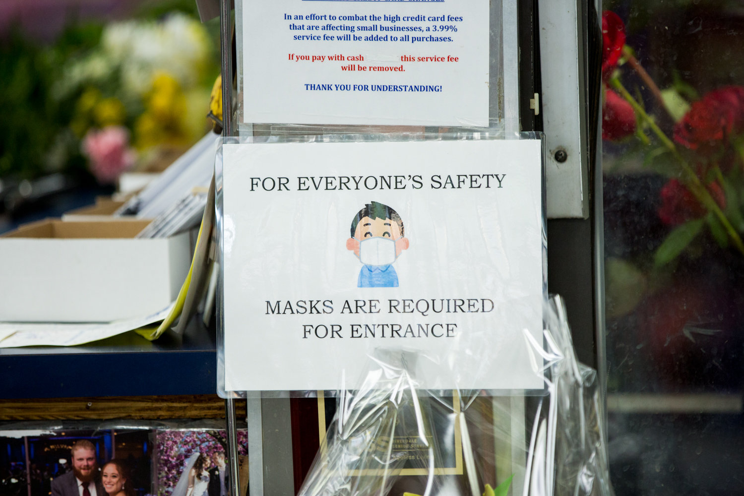 A sign inside Columbia Florist informs customers they must wear a mask when inside the store, especially on busy days leading up to special occasions like Mother’s Day.