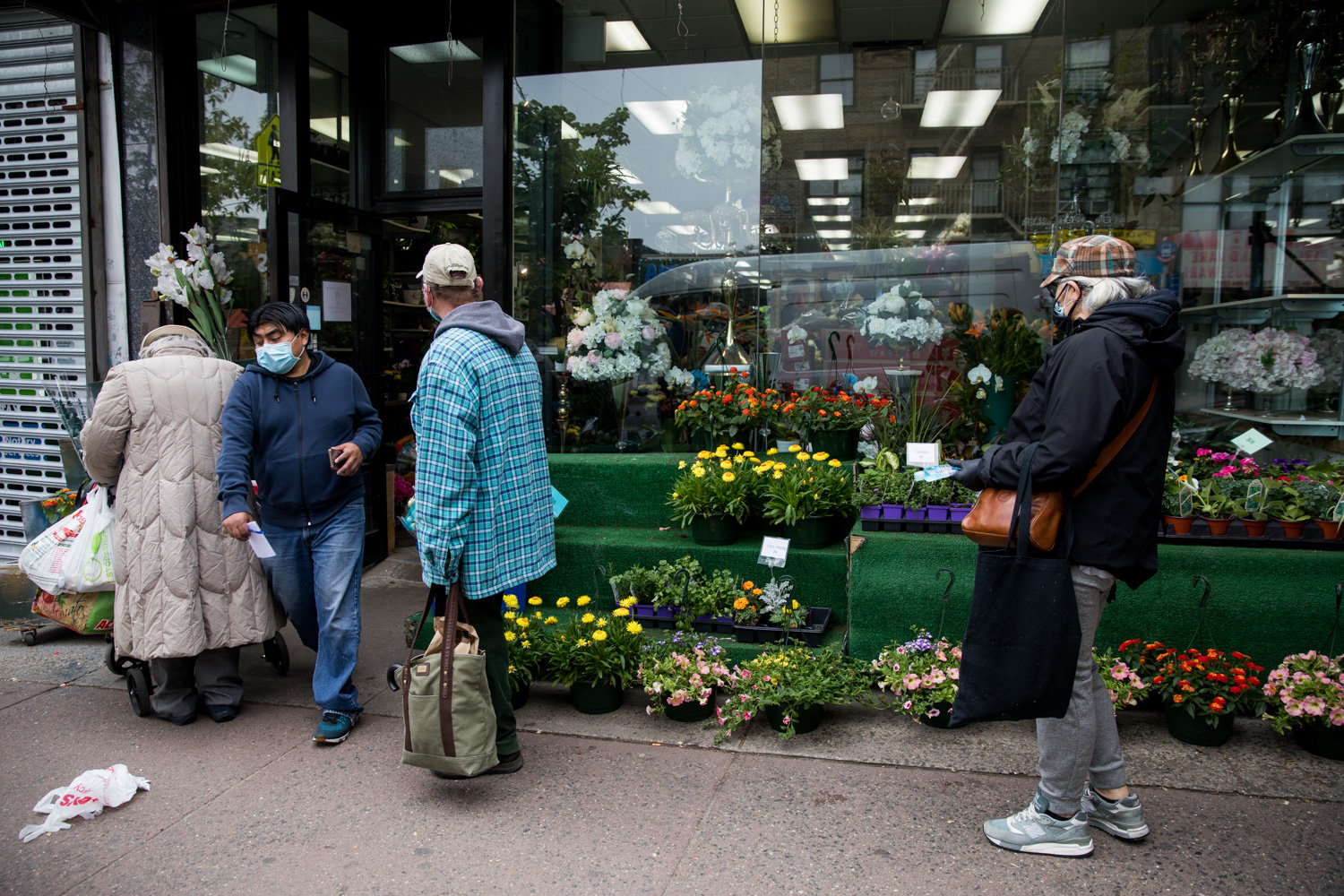 Customers line up along West 231st Street to wait — making an effort to maintain six feet of distance — to get a few minutes inside Columbia Florist just before Mother’s Day.