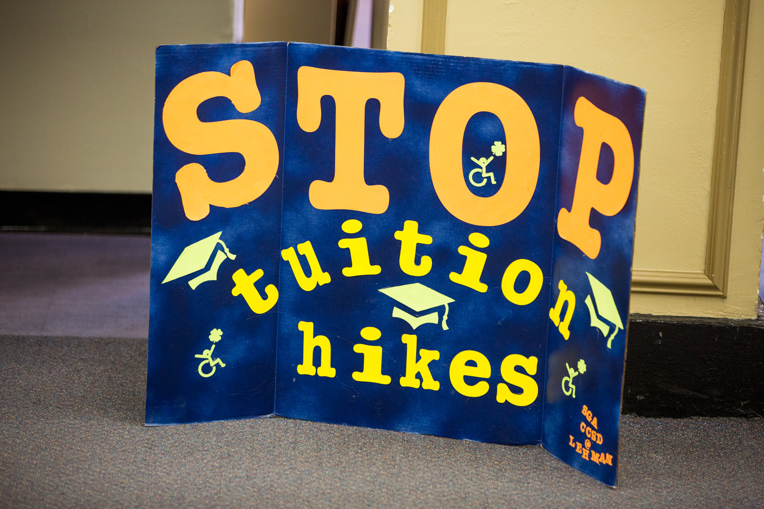 A poster that reads ‘Stop tuition hikes’ stands on the floor during a March 9 forum hosted by the CUNY Rising Alliance at Lehman College, which dealt with proposed budget cuts and tuition hikes.