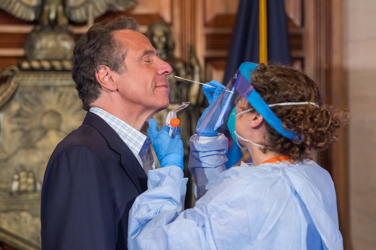 Dr. Elizabeth Dufort conducts a swab diagnostic test of Gov. Andrew Cuomo, looking to see if he has the virus that causes COVID-19. The test was part of a live demonstration Sunday during the governor's daily coronavirus media briefing.