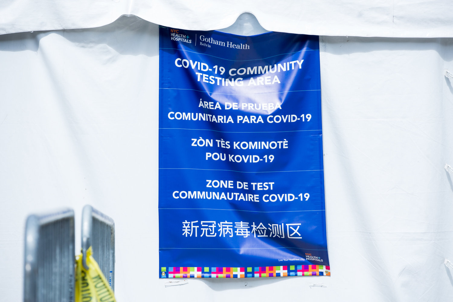 A sign on a tent informs people that NYC Health + Hospitals/Gotham Health, Belvis, is a diagnostic testing area for the coronavirus that causes COVID-19 — one of six testing centers in the borough.
