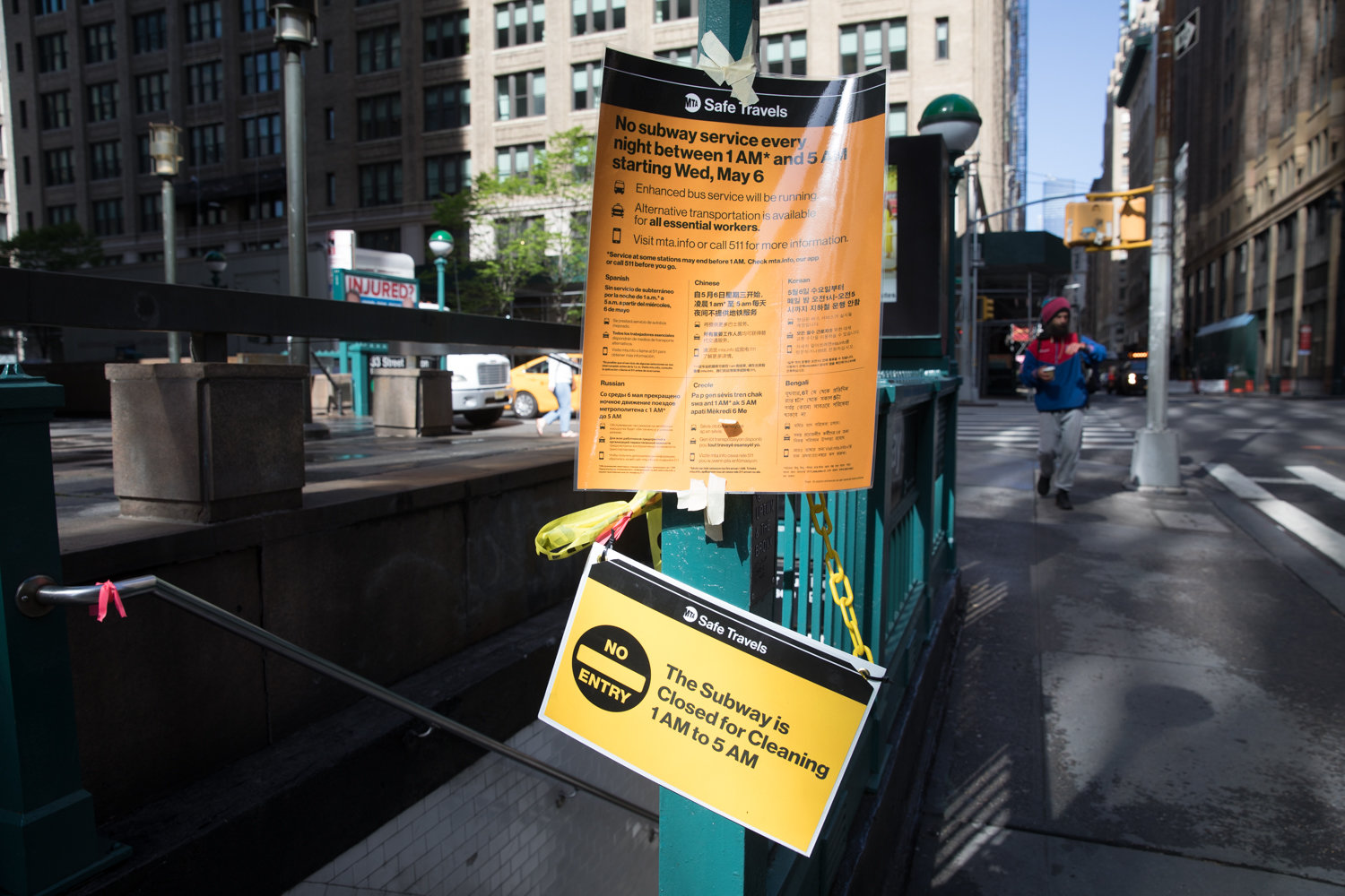 Signs inform passersby of the overnight closure of the subway system beginning at 1 a.m., which not only has made trips by ‘essential’ commuters more difficult, but has also displaced hundreds of homeless people who have found the subway to be a sort of overnight shelter.
