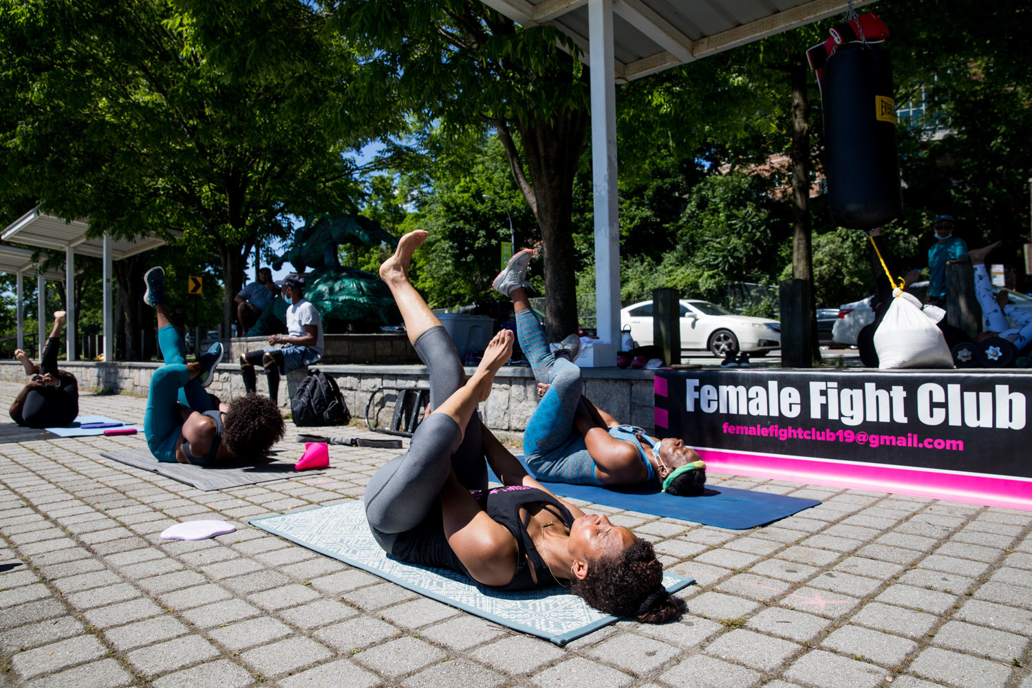 Members of Female Fight Club, a fitness group, cools down with yoga at the end of a workout routine in Van Cortlandt Park. Johanna Edmondson founded the club in the early days of the coronavirus pandemic.