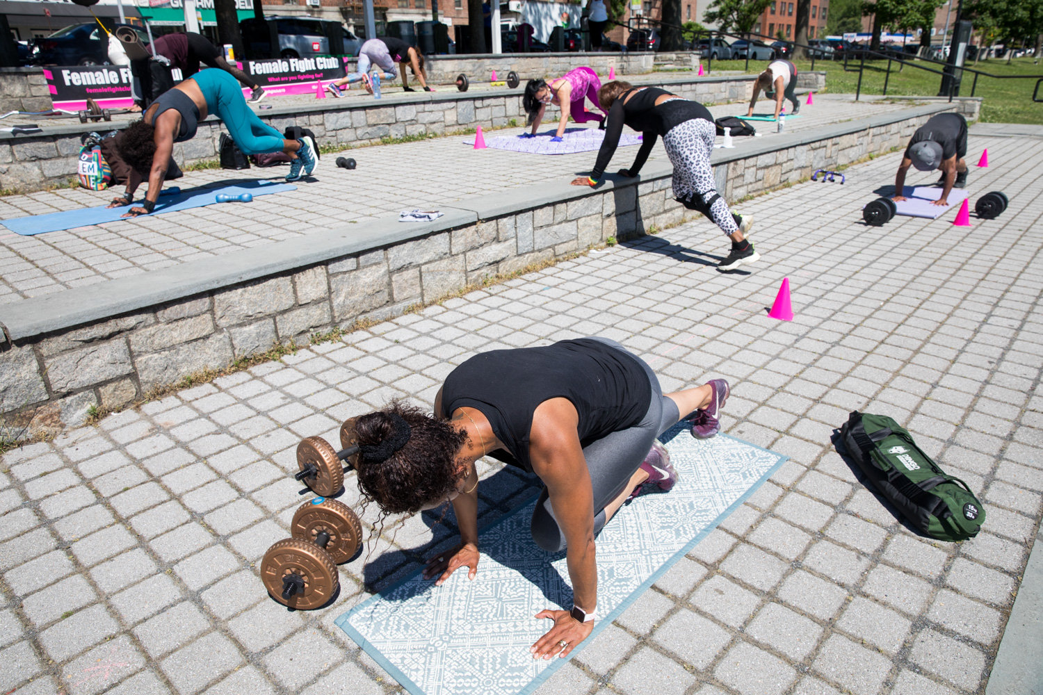 Female Fight Club members do a round of mountain climbers during a session in Van Cortlandt Park.