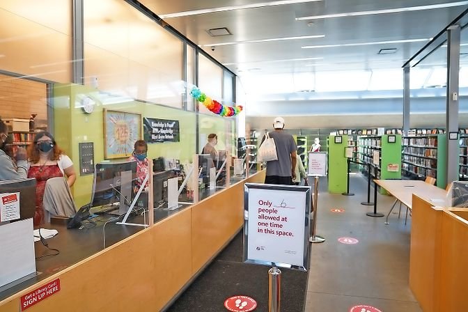Decals on the floor indicate the six-foot distance patrons must maintain when entering the Kingsbridge Library, which partially opened to the public on Aug. 3. For now, patrons may only enter a small section of the West 231st Street library to pick up and return books.