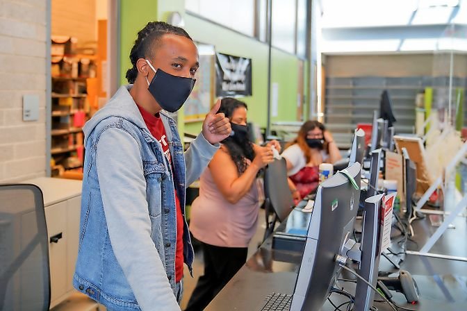 A librarian at Kingsbridge’s West 231st Street branch gives a thumbs up on the location’s first day back open to the public. Masks are required by both employees and patrons entering the building, and only grab-and-go services are being provided at this time.
