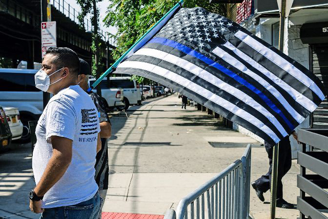 A popular modification to the American flag by law enforcement supporters is to remove all color from the flag, and add a blue line. That line is said to represent what police say is all that separates civilization from chaos, and that officers are that line. Others have described the line as a symbol of police protecting their own, even in the midst of wrongdoing.