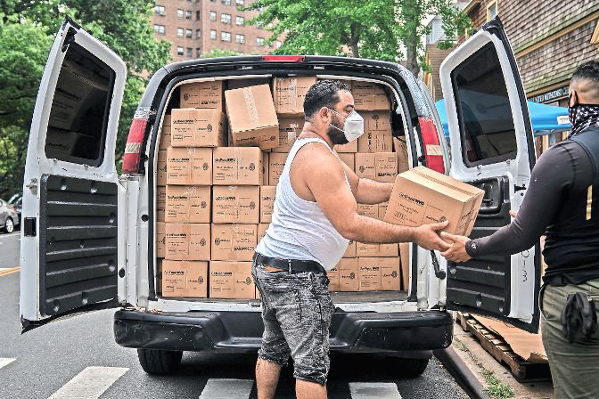 Community Pantry volunteers unpack a van full of food for distribution at St. Stephen’s United Methodist Church. Many food pantries are seeing exponential demand during the coronavirus pandemic, leading to the formation of the Northwest Bronx Food Justice Project, of which St. Stephen’s is a member.