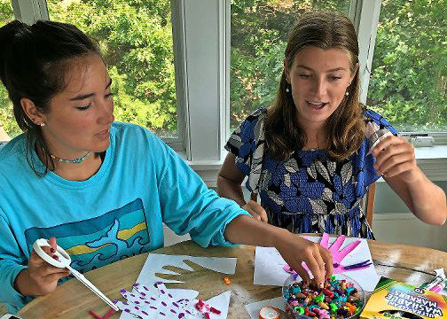 HomeBuddies Mentoring co-founders Katie Koch, left, and Cecilia Needham cut and color hand tracings during a group activity. HomeBuddies, a personalized mentorship program, was designed to provide children with remote mentoring during the height of the coronavirus pandemic.