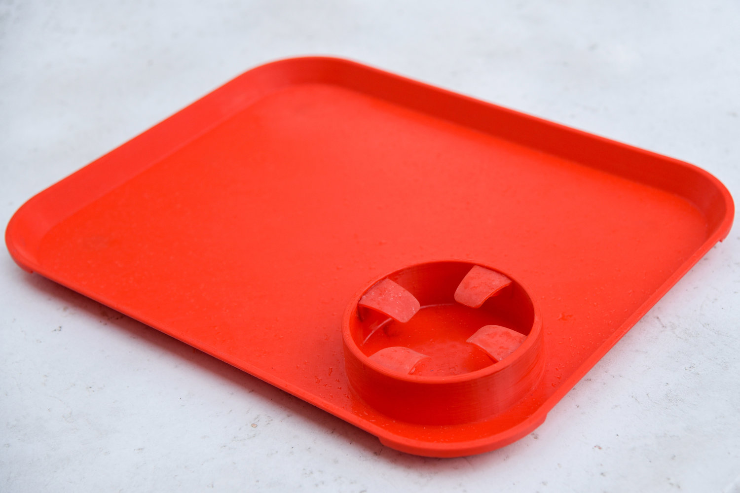 The independent feeding tray prototype features a molded cup with four flaps, intended to help stabilize the tray for those suffering from neurological conditions.