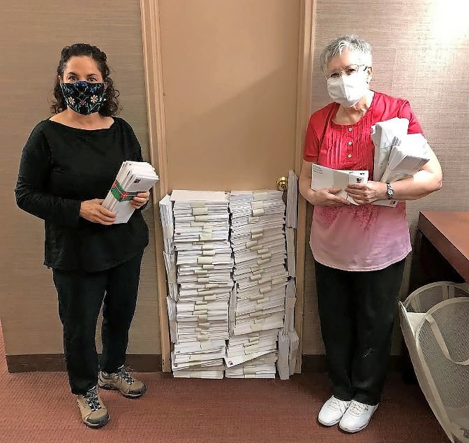 Miriam Levine Helbok, right, joins Kathy Solomon to show the 2,705 letters she wrote to voters in a half-dozen states that were mailed last week, urging them to vote Nov. 3. Solomon introduced Helbok to this particular get-out-the-vote project, launched last year by political group Vote Forward.