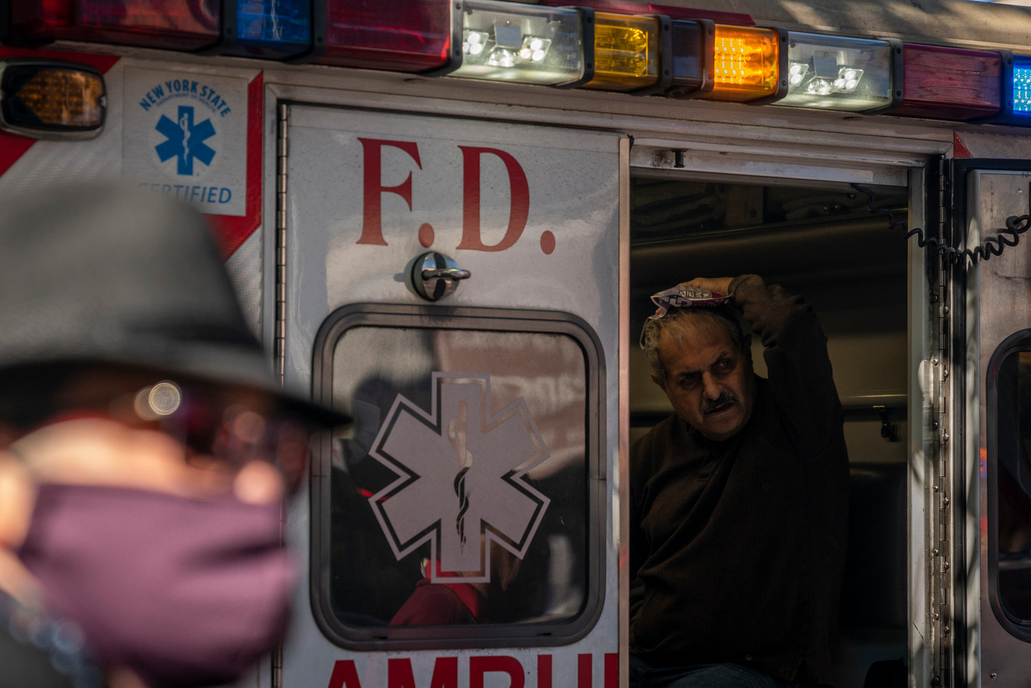 Paramedics treat Nohad Jourdy minutes after pulling him out of the rubble created by a ceiling that collapsed on both him and his wife, Samia, at Picture Perfect Frames on West 231st Street.