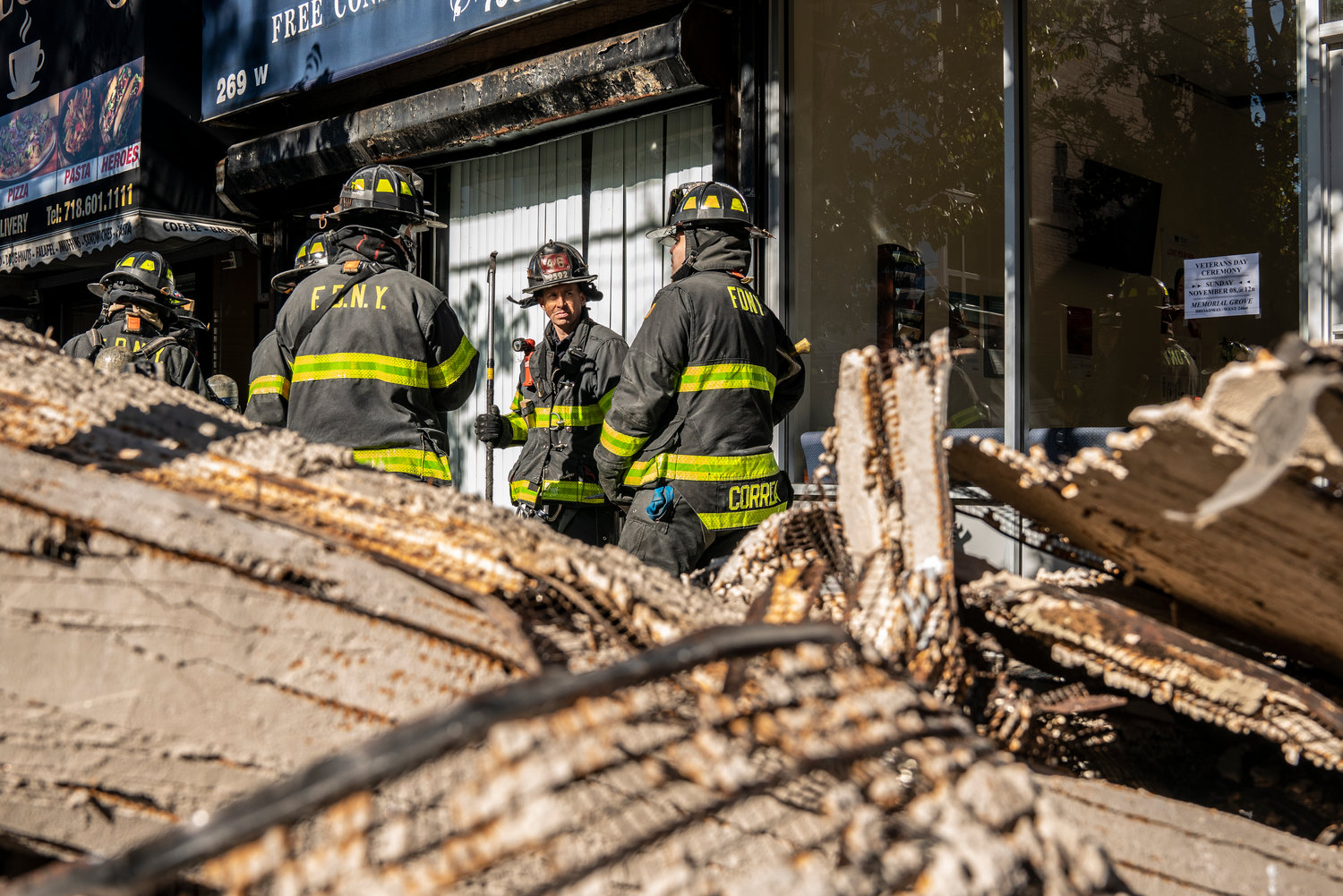 New York firefighters take a moment to assess the rubble they pulled out of the Picture Perfect Frames store at 267 W. 231st St. The wire lath and plaster ceiling fell Monday, burying its owners, Nohad and Samia Jourdy. Luckily, both escaped serious injury.