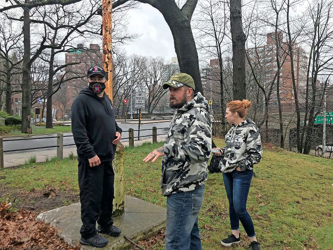 Tree Army owner Nicholas Lynch and wife Joelle check out the status of the old flagpole near the Riverdale Monument on West 239th Street with Danny Monge. The three are putting together a small group they hope can restore the flagpole and have the stars and stripes flying on top of it in time for Flag Day in June.