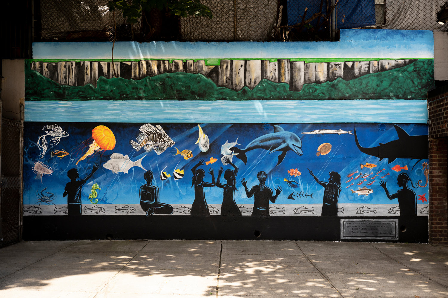 The mural ‘Aquarium’ on the back side of 3636 Greystone Ave., features a view of the Palisades and an imagined aquarium at the bottom of the Hudson River. Artist Nicky Enright was commissioned by his co-op board to paint the piece thanks to his experience in doing such works in the past.
