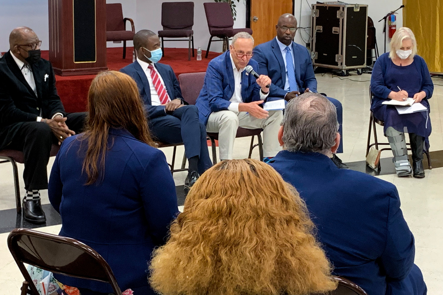 U.S. Senate Majority Leader Chuck Schumer pushes to make monthly child poverty payments that started under the American Rescue Plan permanent in a Yonkers town hall that included U.S. Treasury Department deputy secretary Wally Adeyemo, left, and U.S. Rep. Jamaal Bowman.