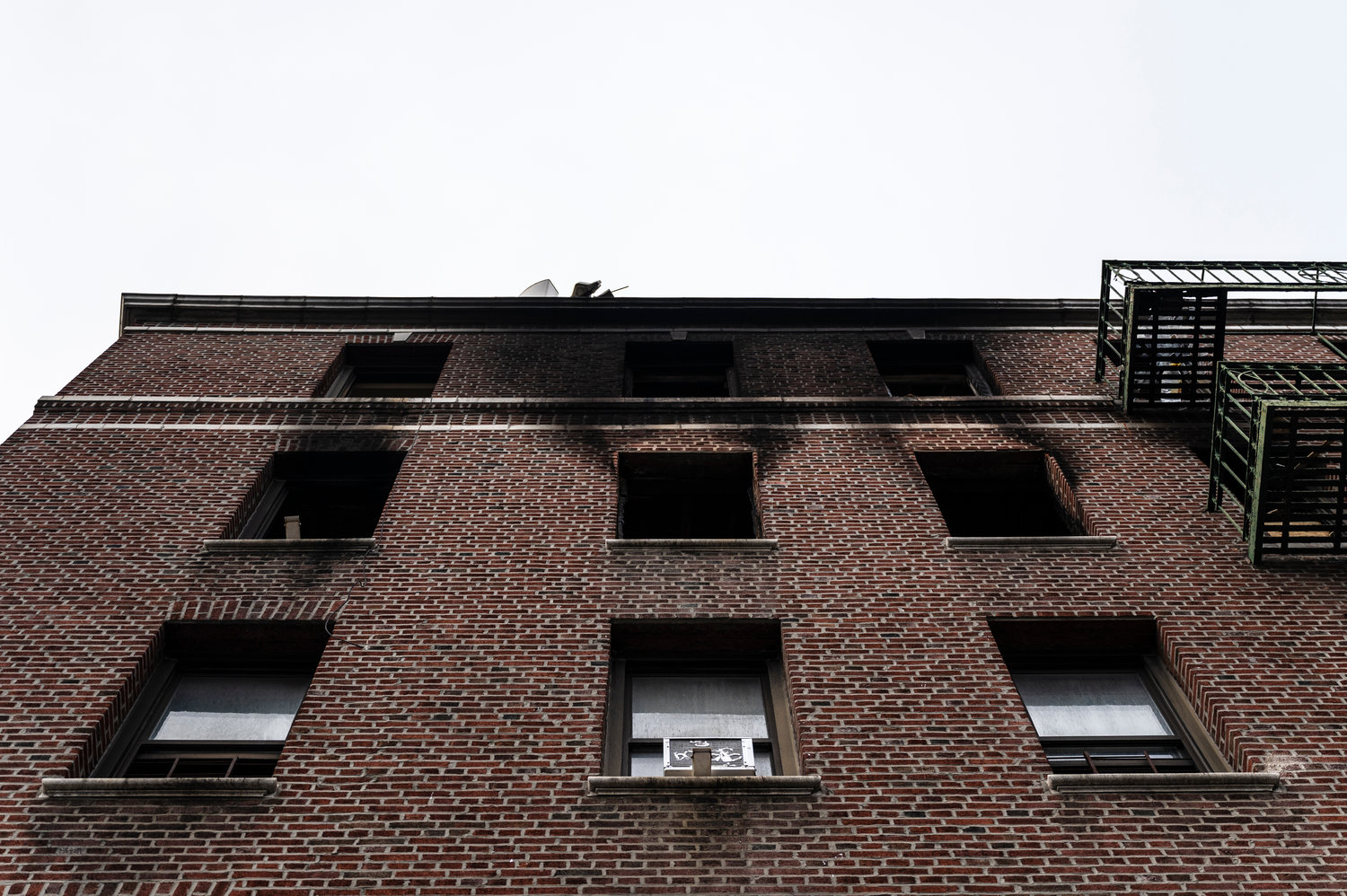 Soot on the exterior of the top two floors of 181 W. 238th St., tell us all we need to know about what happened last September when a blaze damaged or destroyed more than a dozen units, with many of those tenants still not sure on when they might be able to return.