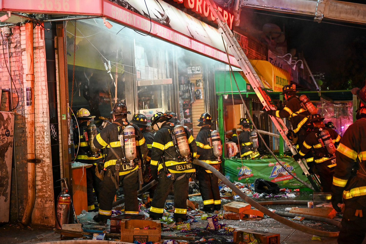 Firefighters work to try and salvage as much of the Bailey Deli & Grocery store as they can as fire raced through the popular bodega on the corner of Bailey Avenue and West 238th Street. Investigators believe the four-alarm fire started in the nearby Yeung Hing Restaurant, and ultimately damaged four other businesses.