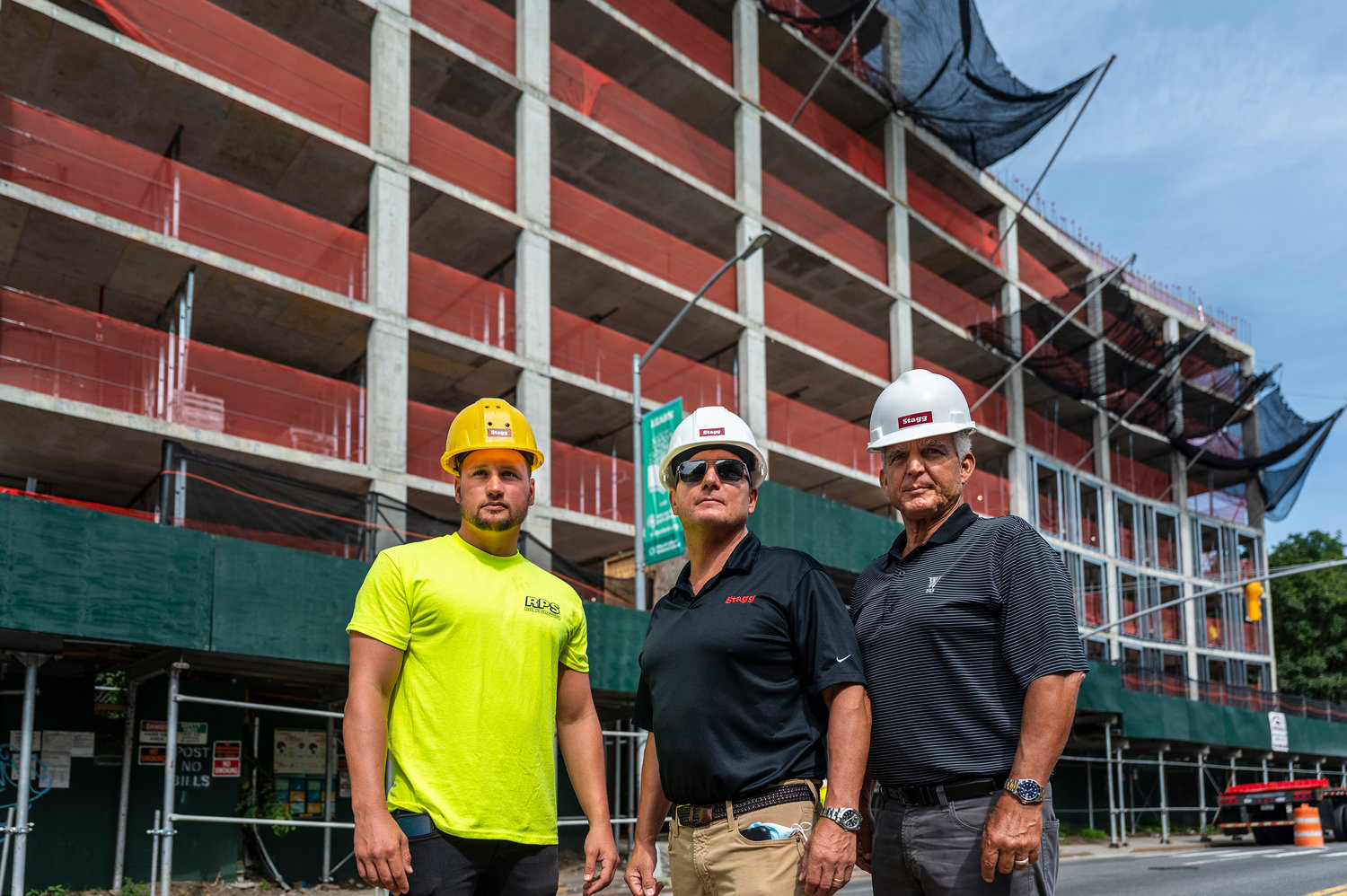 Ryan Stagg, left, joins Mark Stagg and Jay Martino from the balcony of their 5278 Post Road apartment construction project last year. The Stagg Group has been one of the most active developers in this part of the Bronx for the last decade, known for rescuing other development projects that just never came together. The group is poised to do that yet again — this time at 3745 Riverdale Ave. — which they hope to build an apartment complex where Montefiore Medical Center once planned to build medical offices.