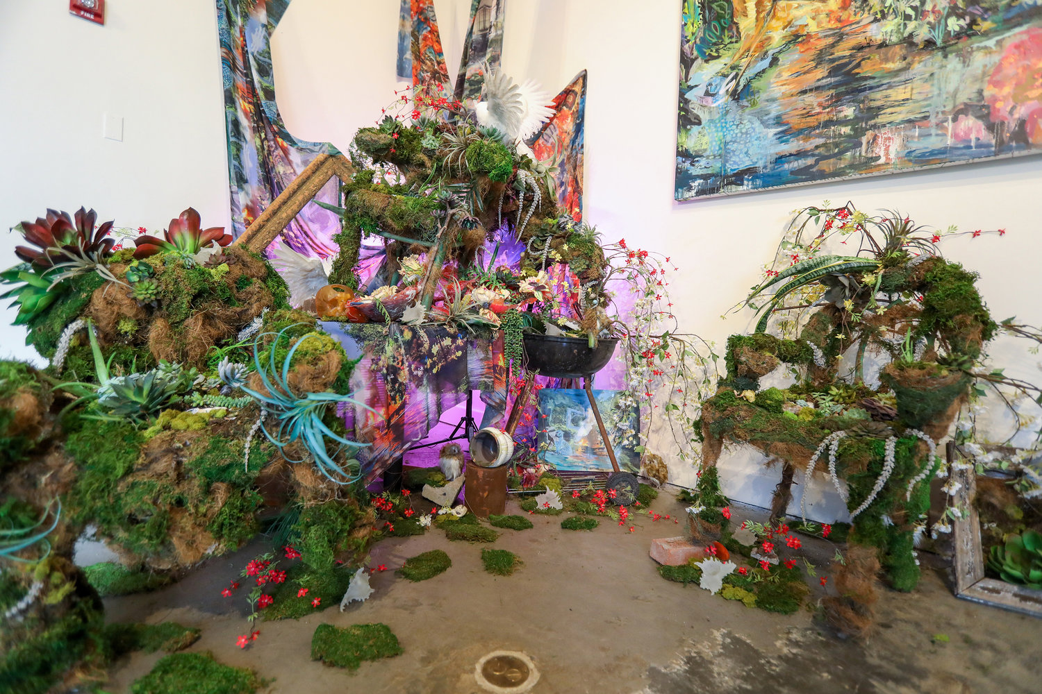 Natalie Collette Wood’s ‘The Dinner After the Storm,’ which she says depicts an ‘abandoned dinner party that's gone awry with animals and natural plants and moss and succulents taking over,’ is part of ‘Eco-Urgency: Now or Never’ — an exhibition focused on the effects of climate change currently showing at the Lehman College Art Gallery.