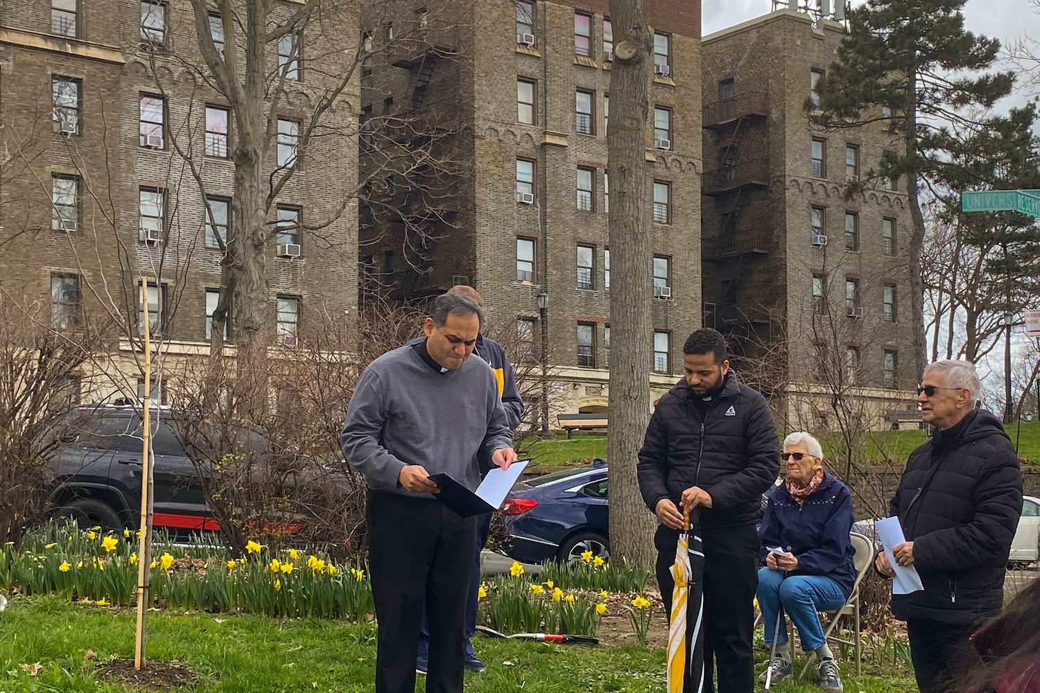 Father Joseph Franco of Out Lady of Angels Church in Kingsbridge Heights blesses three rosebud trees planted in memory of those who perished during COVID-19 over the past two years. The ceremony took place April 9 in a park at the corner of University and Reservoir avenues in Kingsbridge Heights.