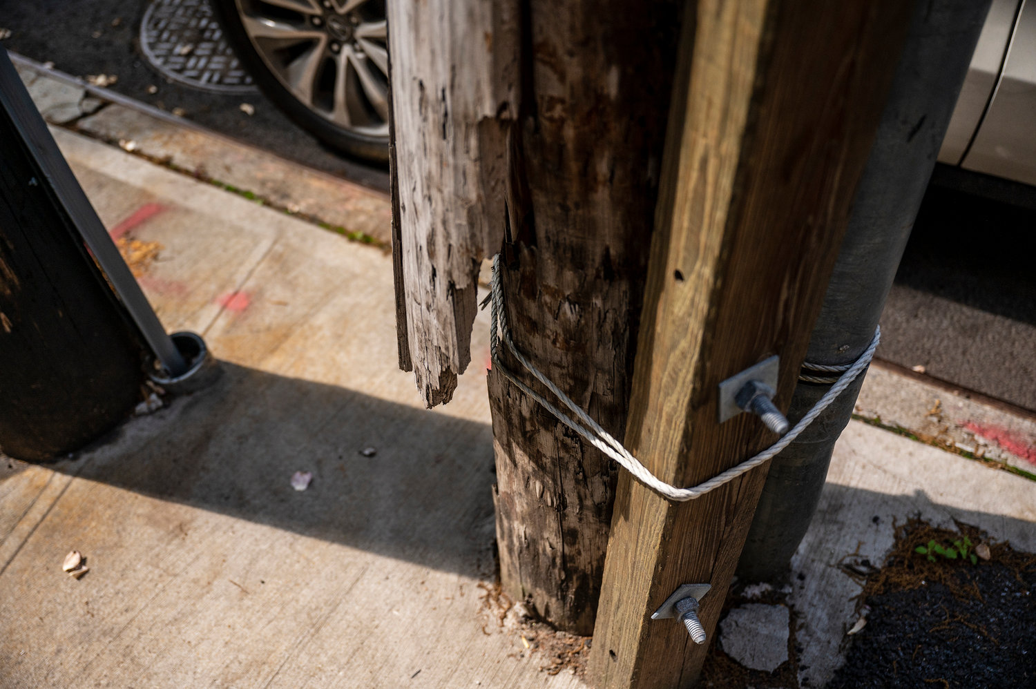 On Sedgwick Avenue there is a broken utility pole that is held in place with screws. Wood and rope were placed by Con Edison in a temporary fashion to prevent immediate danger for the neighborhood.