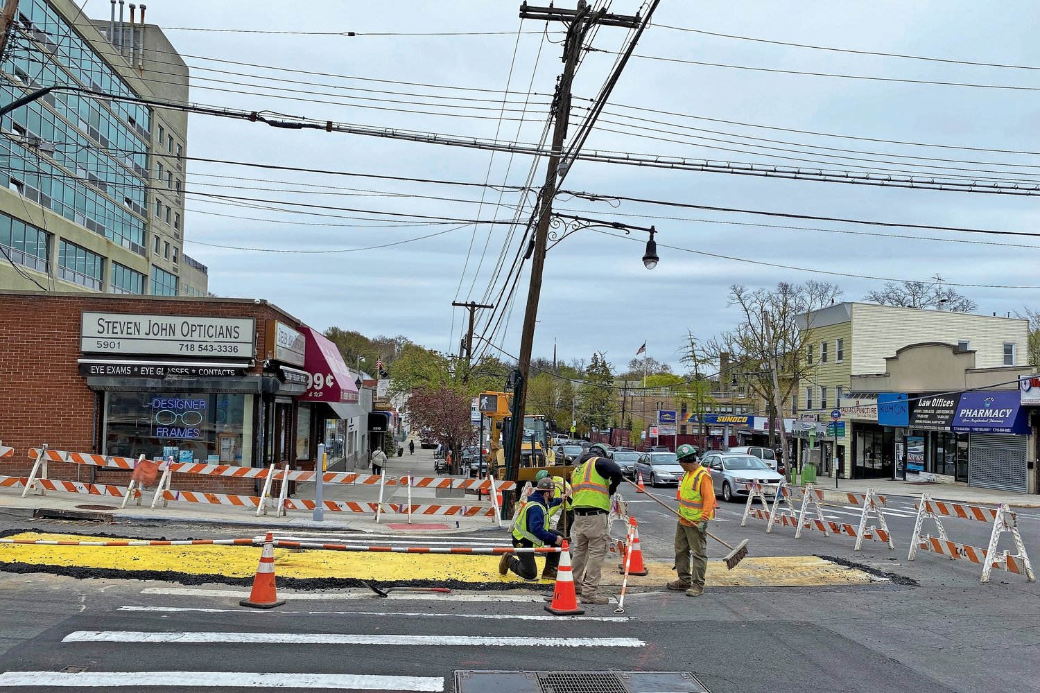 Workers finish making repairs to underground utilities on 259th Street at the intersection of Riverdale Avenue on April 25. They placed steel plates at two sections of the intersection over a couple of days. With construction vehicles still parked nearby, it seems their work is not yet done.