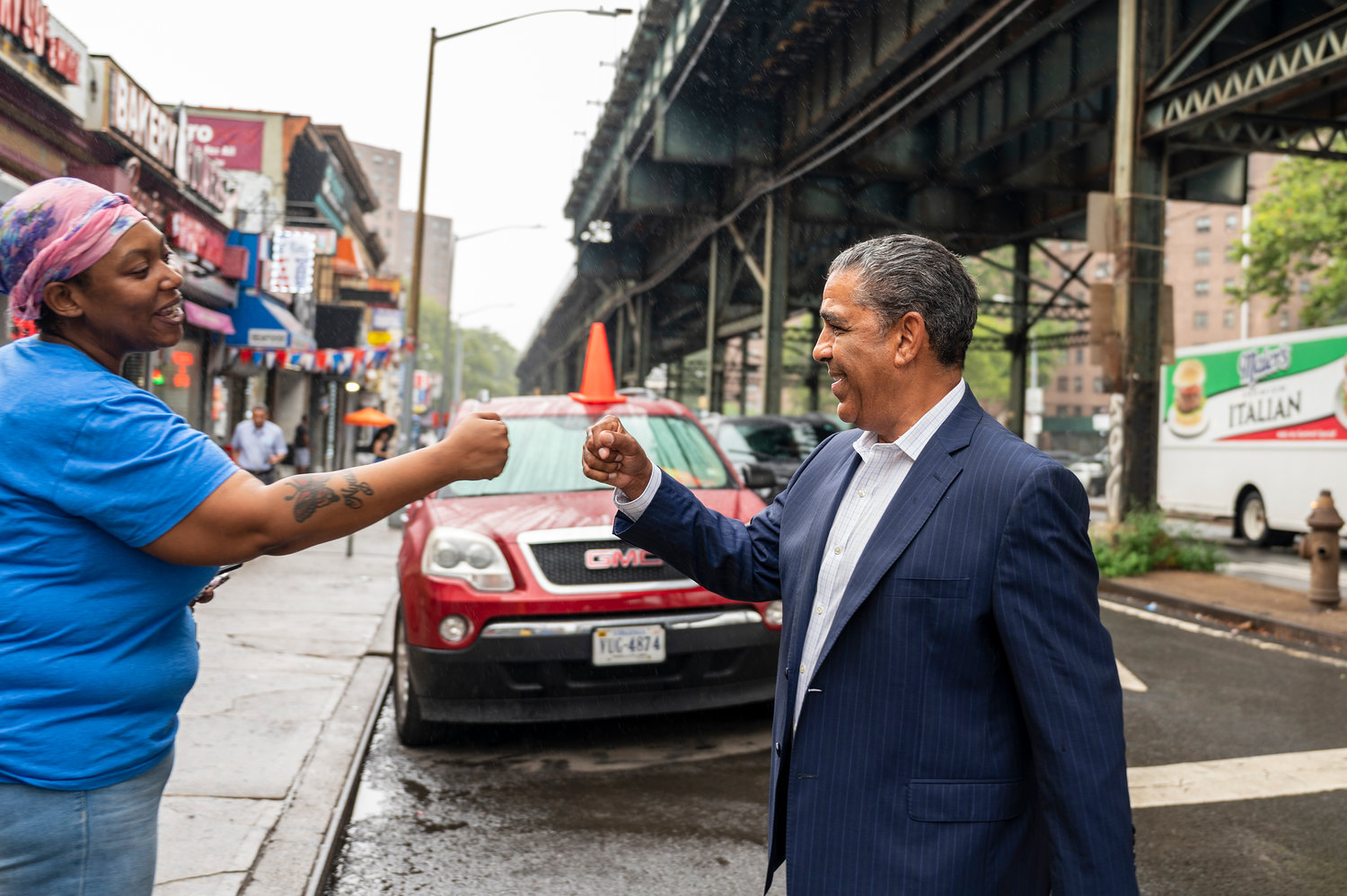 U.S. Rep. Adriano Espaillat visits with some of his constituents in Marble Hill last week, as he campaigns to make yet another return trip to Washington.