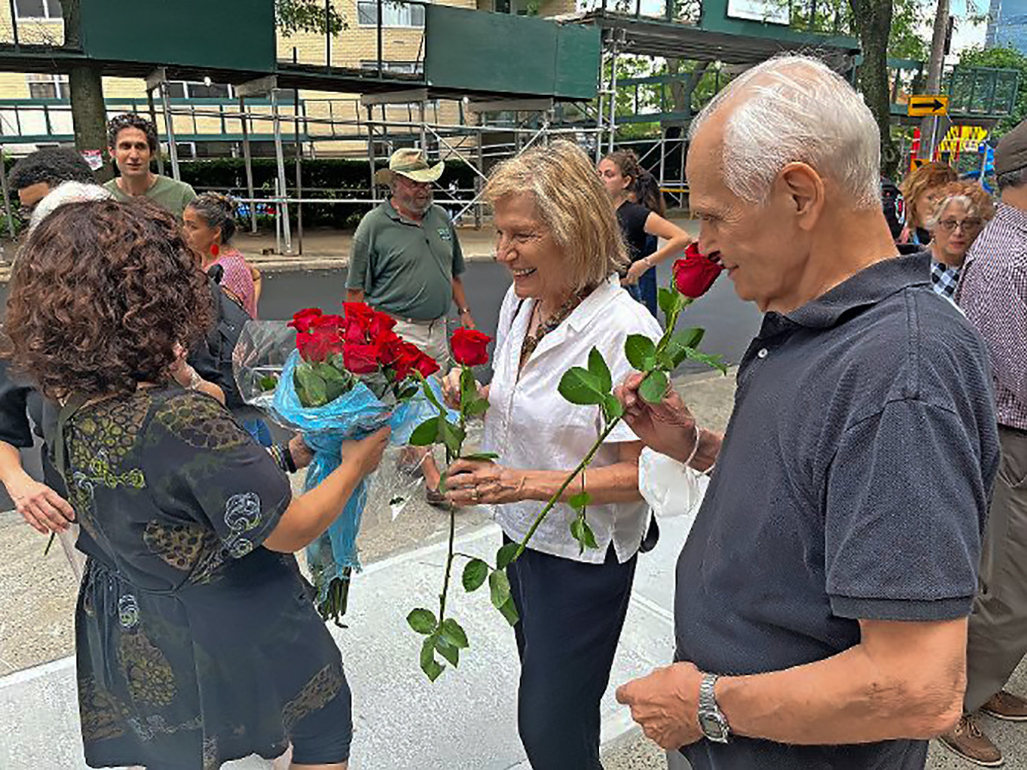 Jude Tuber, a first assistant director on the 1987 John Malkovich film ‘Making Mr. Right,’ smells a rose intended to honor his late friend and colleague, Ruth Mullen, who was killed last year while crossing at the intersection of Kappock Street and Johnson Avenue just a few yards away,