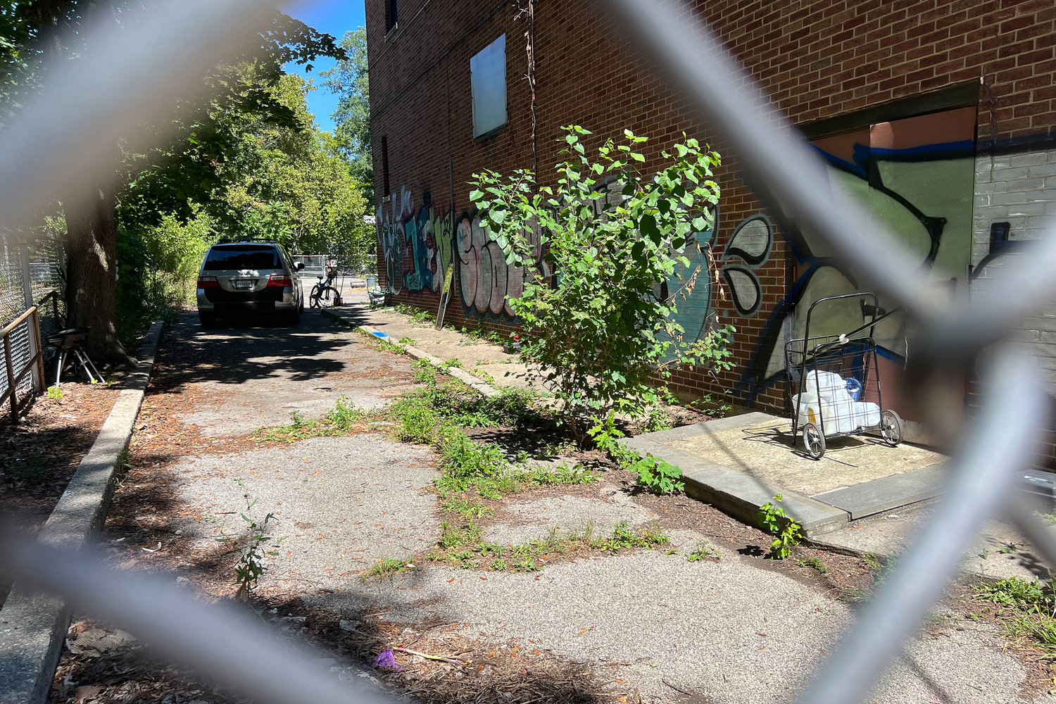 A van was parked in the driveway of the former Church of the Visitation parish school Aug. Tishman Speyer said they hired the van driver to provide security at the property until demolition begins.