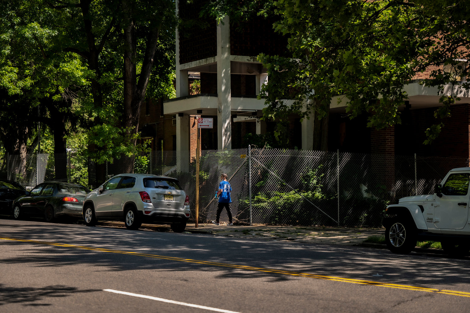 A pedestrian walks past the shuttered Church of the Visitation of the Blessed Virgin Mary that sits across from Van Cortlandt Park.