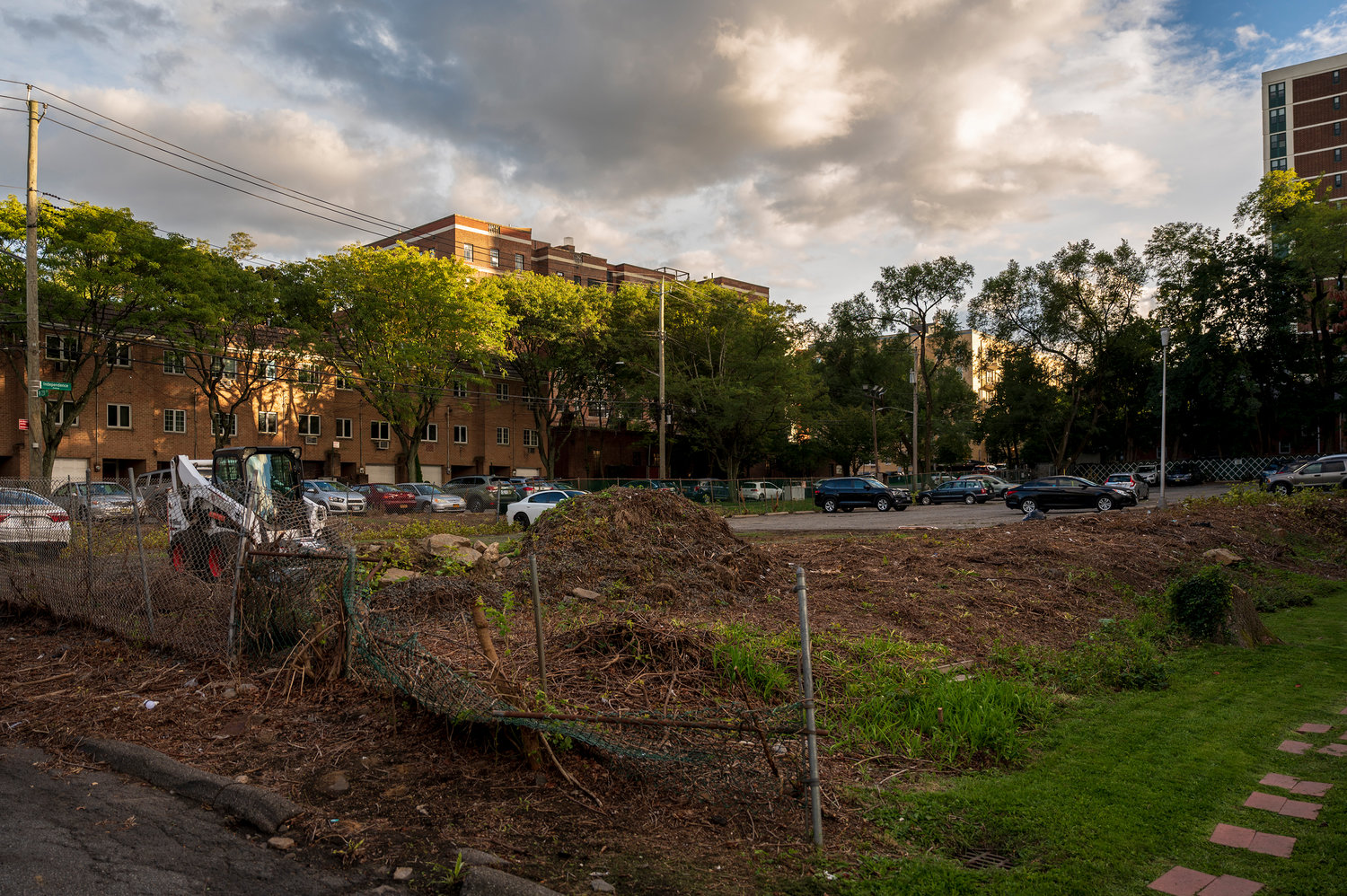 Landscaping equipment and a pile of earth remain after excavation work at a parking lot used by the Schervier Rehabilitation and Nursing Center's staff at the intersection of Independence Ave and W 231st St on Wednesday, September 28, 2022.