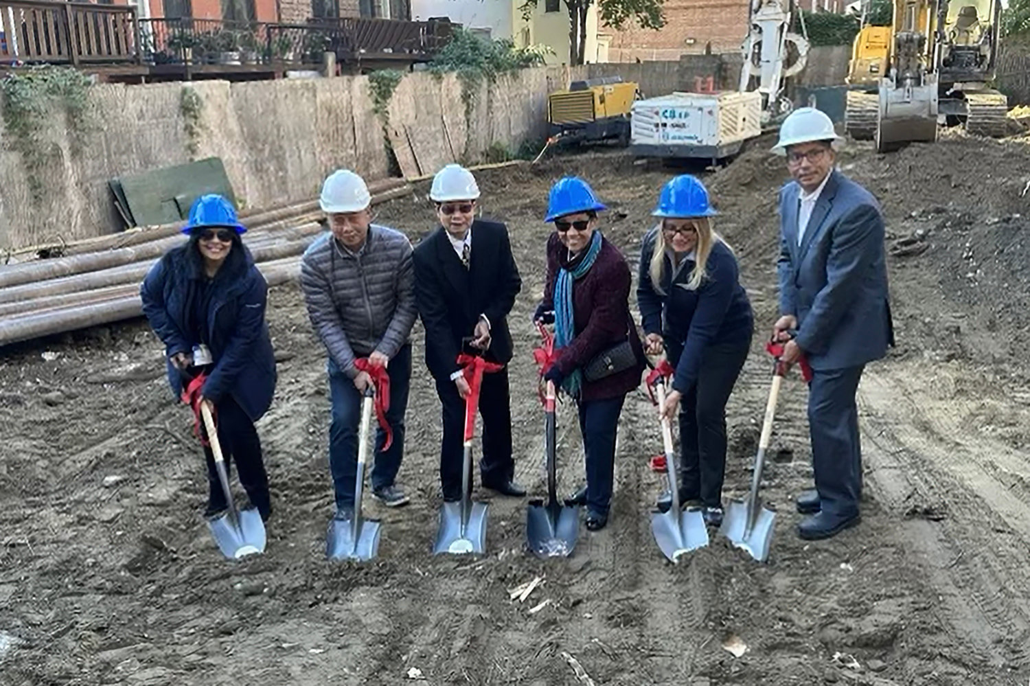 Members of the International Leadership Charter School administration and the developer break ground in a ceremony recently where a new middle school is being built.